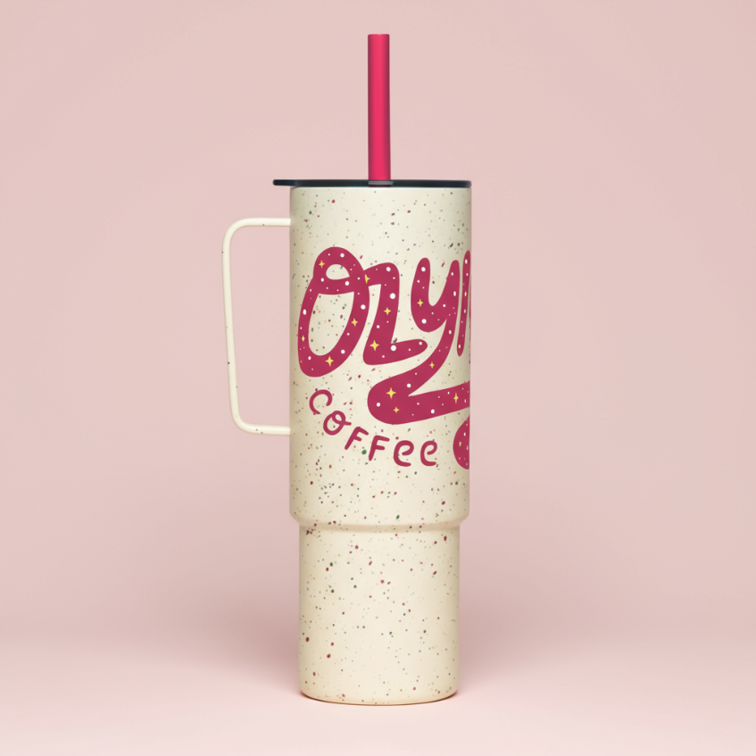 Tumbler with pink 'Ozzy Coffee' text on a pink background