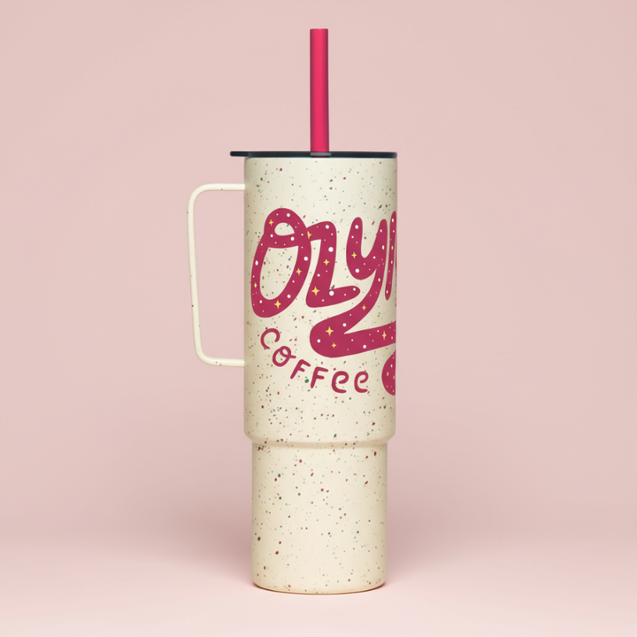 Tumbler with pink 'Ozzy Coffee' text on a pink background